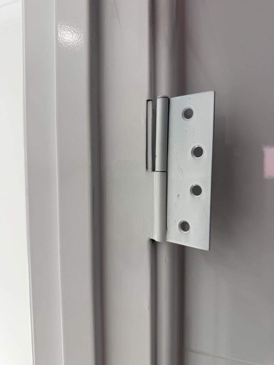 New hinge fitted to a painted steel frame