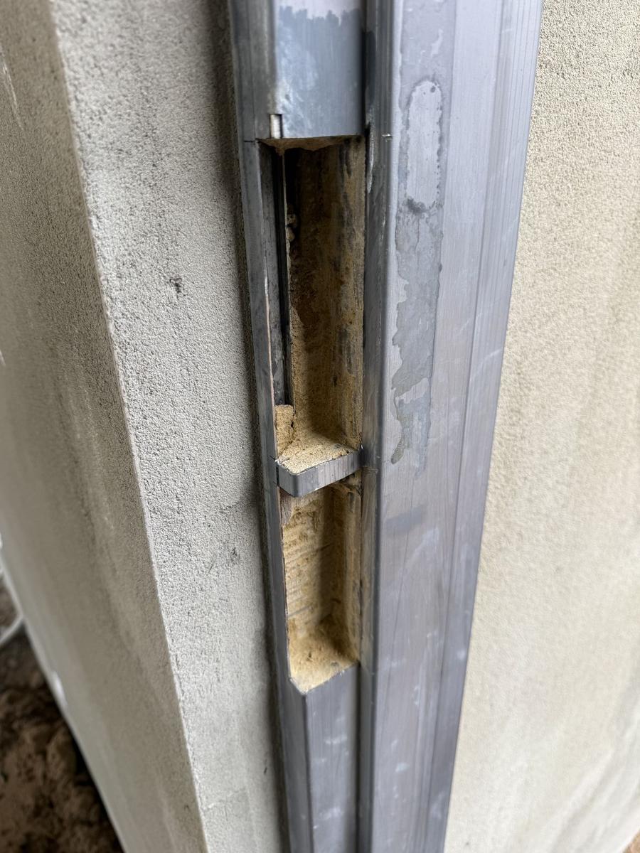 Galvanised frame opened up on a rendered wall